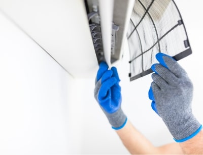 Technician changing out AC filter